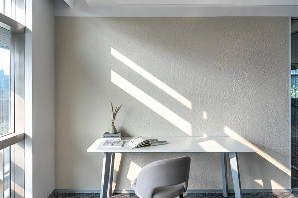 Textured panels used on the wall in study room with table and chair | Everest Industries
